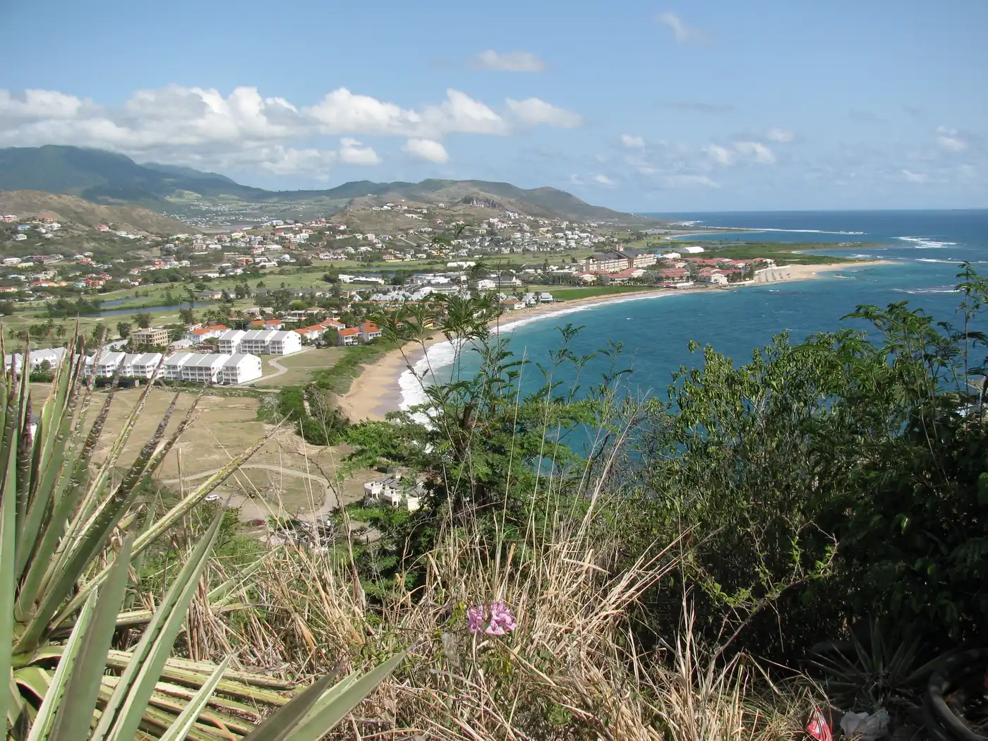 Green hills and the bay at Frigate Bay on St Kitts